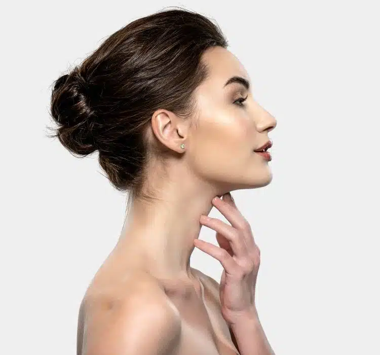 Woman flexing her chin promoting Kybella non-surgical treatment for double chin in Aurora, CO